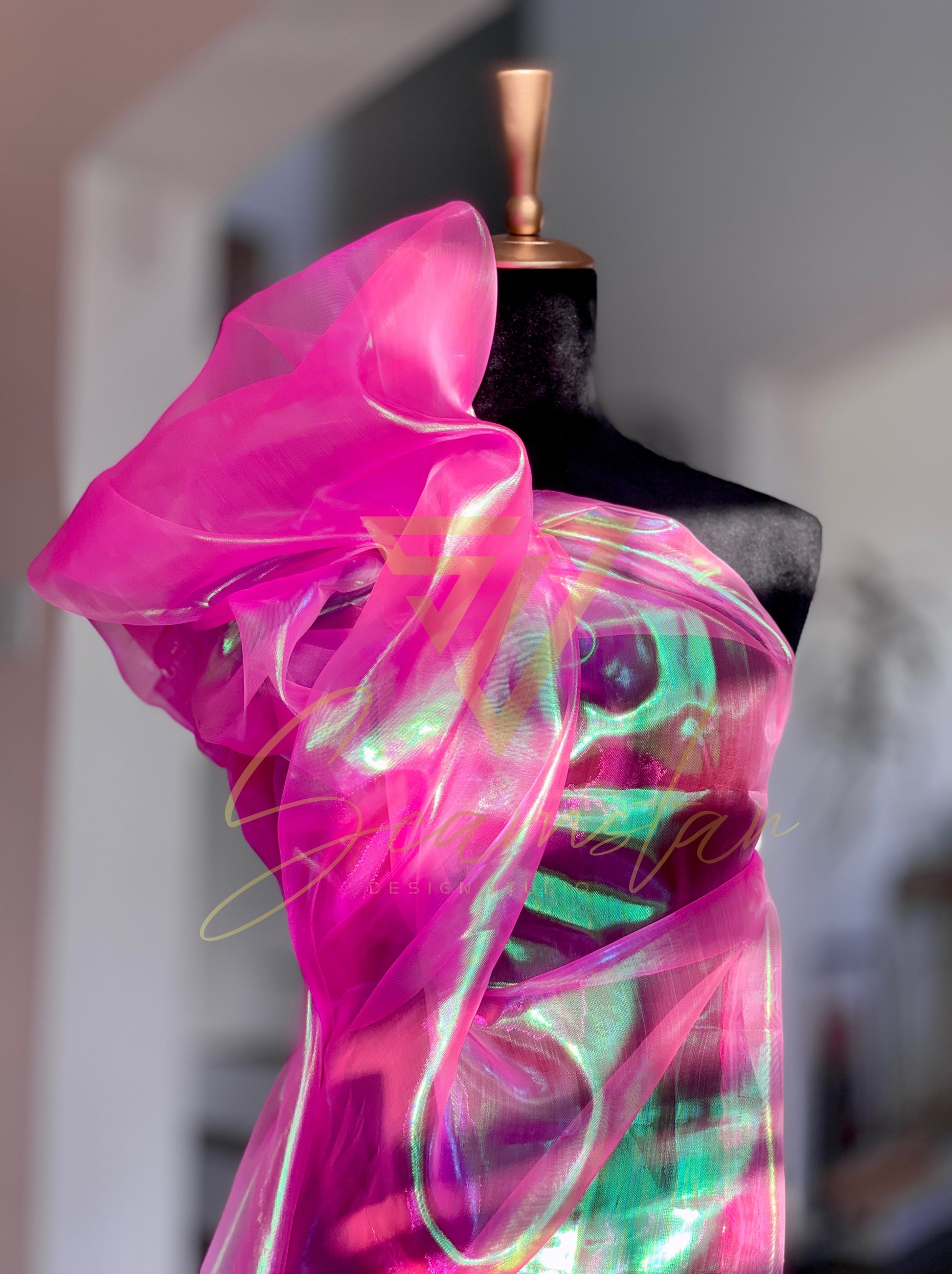 Bring vibrant energy and a touch of glamour to your next creative project with this eye-catching iridescent Organza fabric. Make a striking impression by creating dazzling garments, statement decorations, or unique craft items.